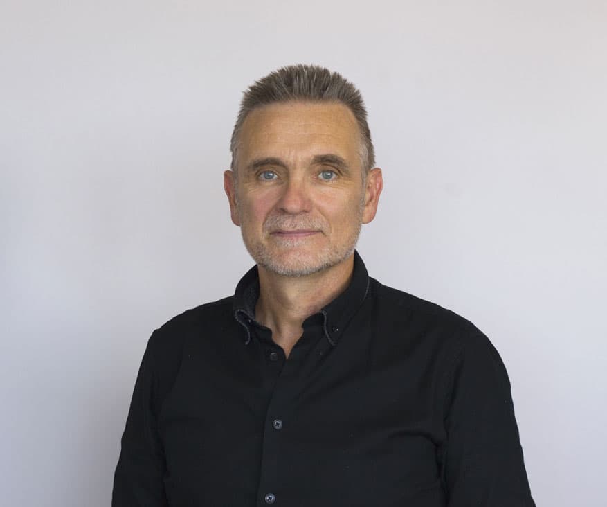 Portrait of André, President and Technical Director of AAMS, overseeing device design and manufacturing operations.