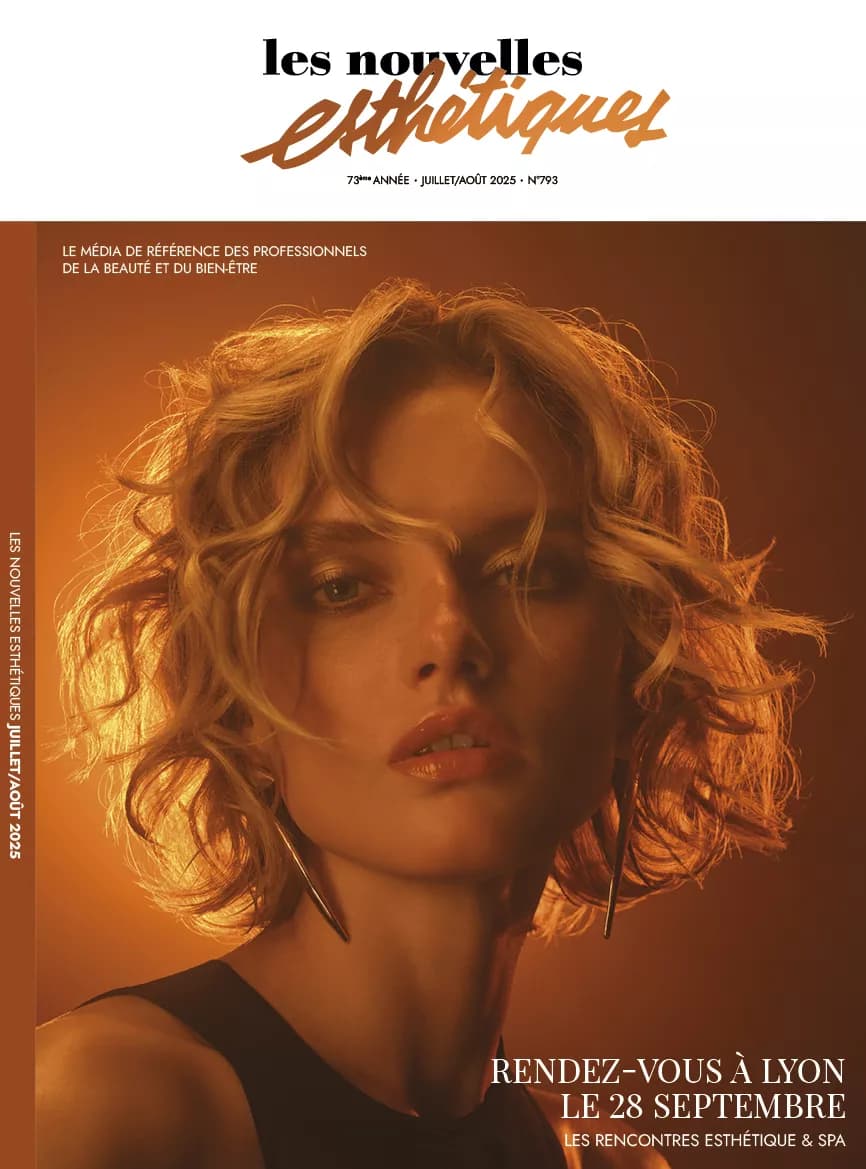 Magazine cover featuring a portrait of a woman with blonde hair against a warm, amber-toned background with editorial text overlays.