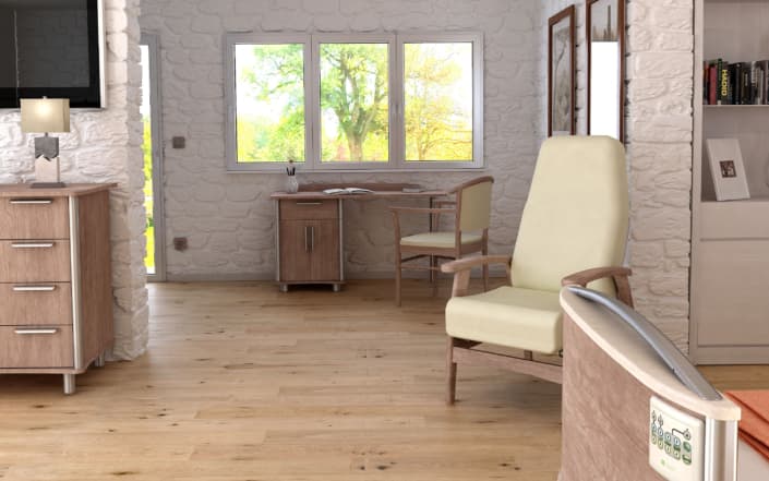 A furnished room featuring a wooden desk, chair, and medical-style furniture with a control panel, resembling a residential care facility interior.