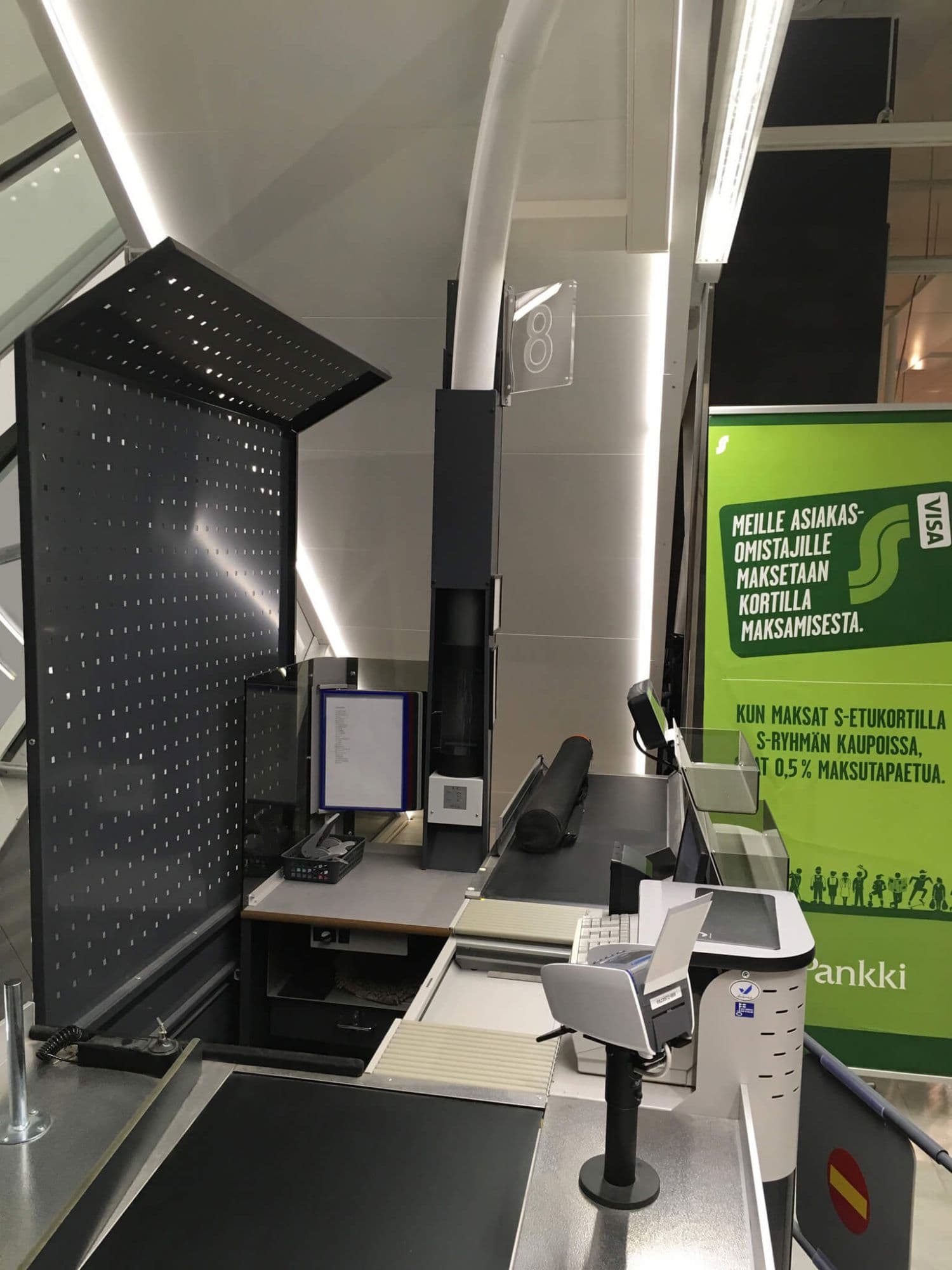 Pneumatic tube station installed at a supermarket checkout counter for secure cash logistics.