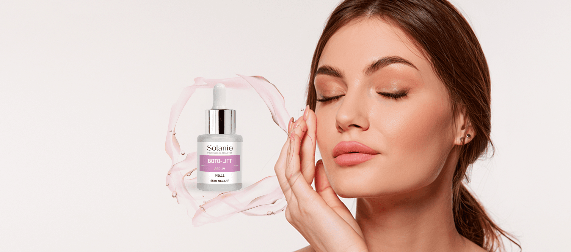 A woman with closed eyes touches her cheek next to a floating bottle of Solanie Boto-Lift serum surrounded by a pink liquid splash.