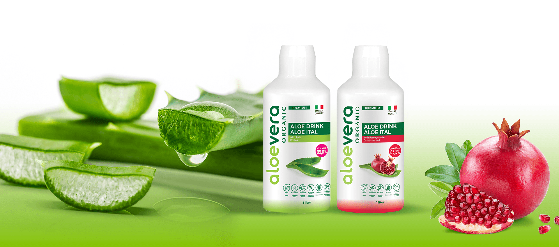 Two bottles of organic aloe vera drink displayed alongside fresh aloe vera leaves and a pomegranate on a green gradient background.