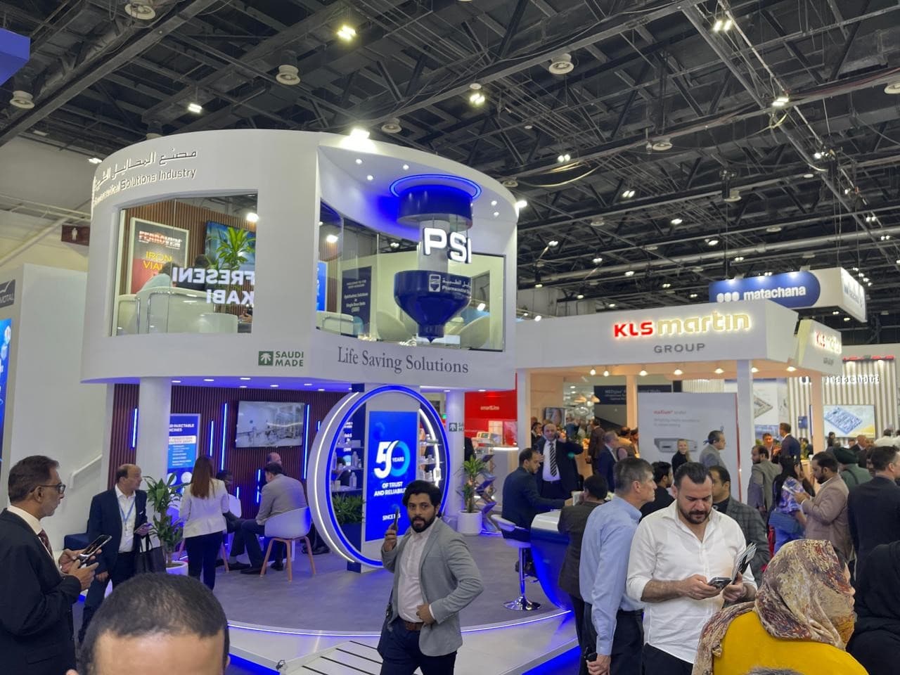 Company exhibition booth at a trade show, featuring branding, product displays, and staff engaging with visitors.