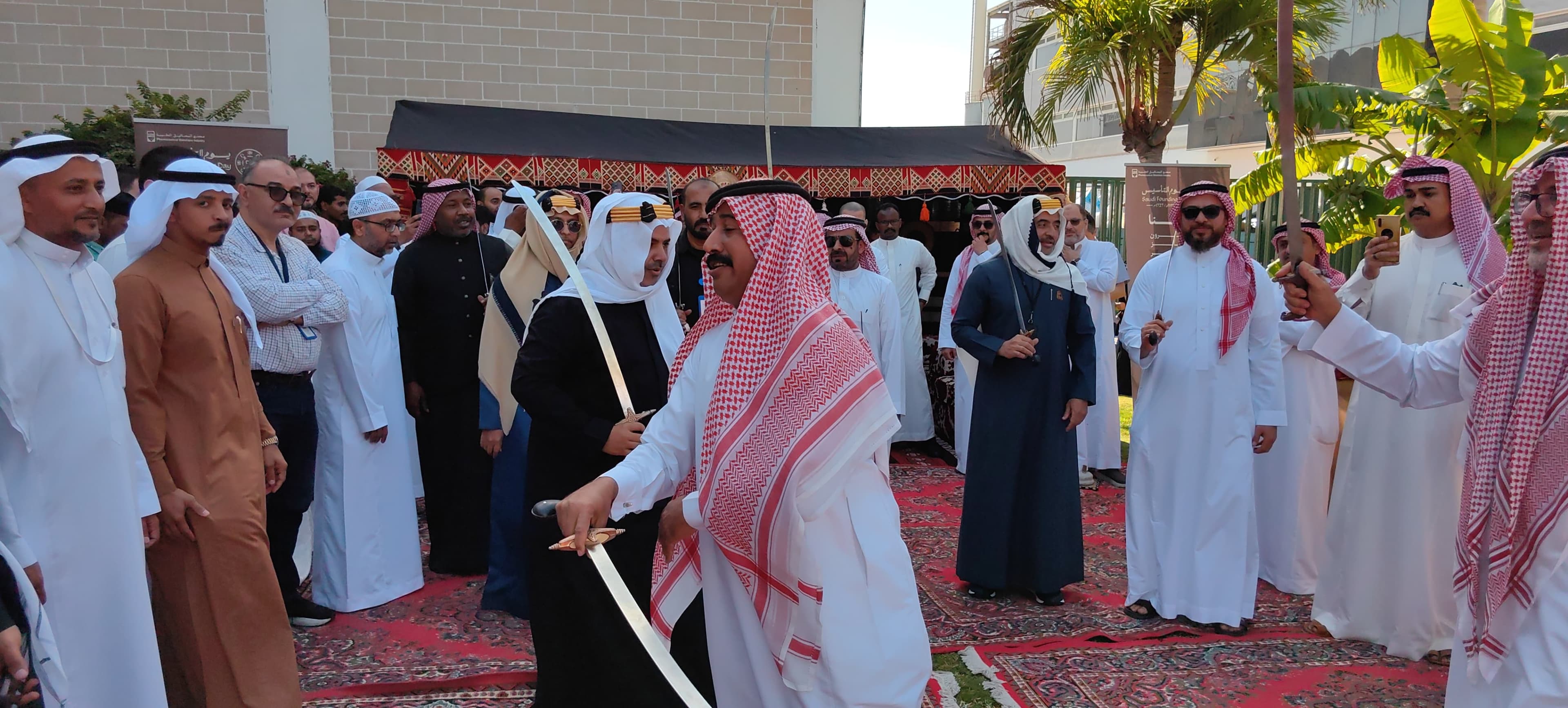 Employees participating in a traditional sword dance during the company's founding day celebration event.