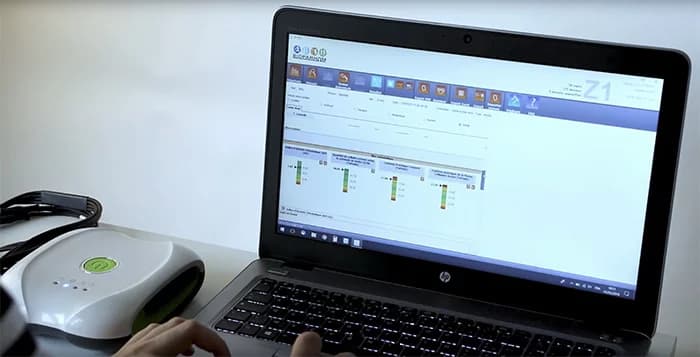 A laptop screen displays the Bioparhom Z1 software interface with data visualization charts, positioned next to a connected medical device.