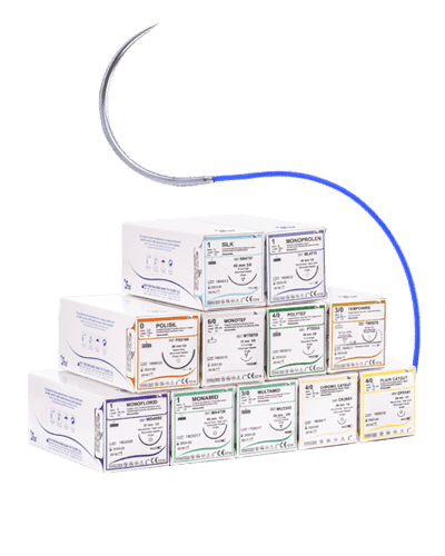 A stacked collection of various surgical suture boxes with a single curved needle and blue thread extending from the top.