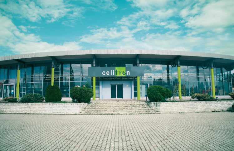 Exterior view of the Celitron manufacturing facility, featuring modern glass architecture and company branding.