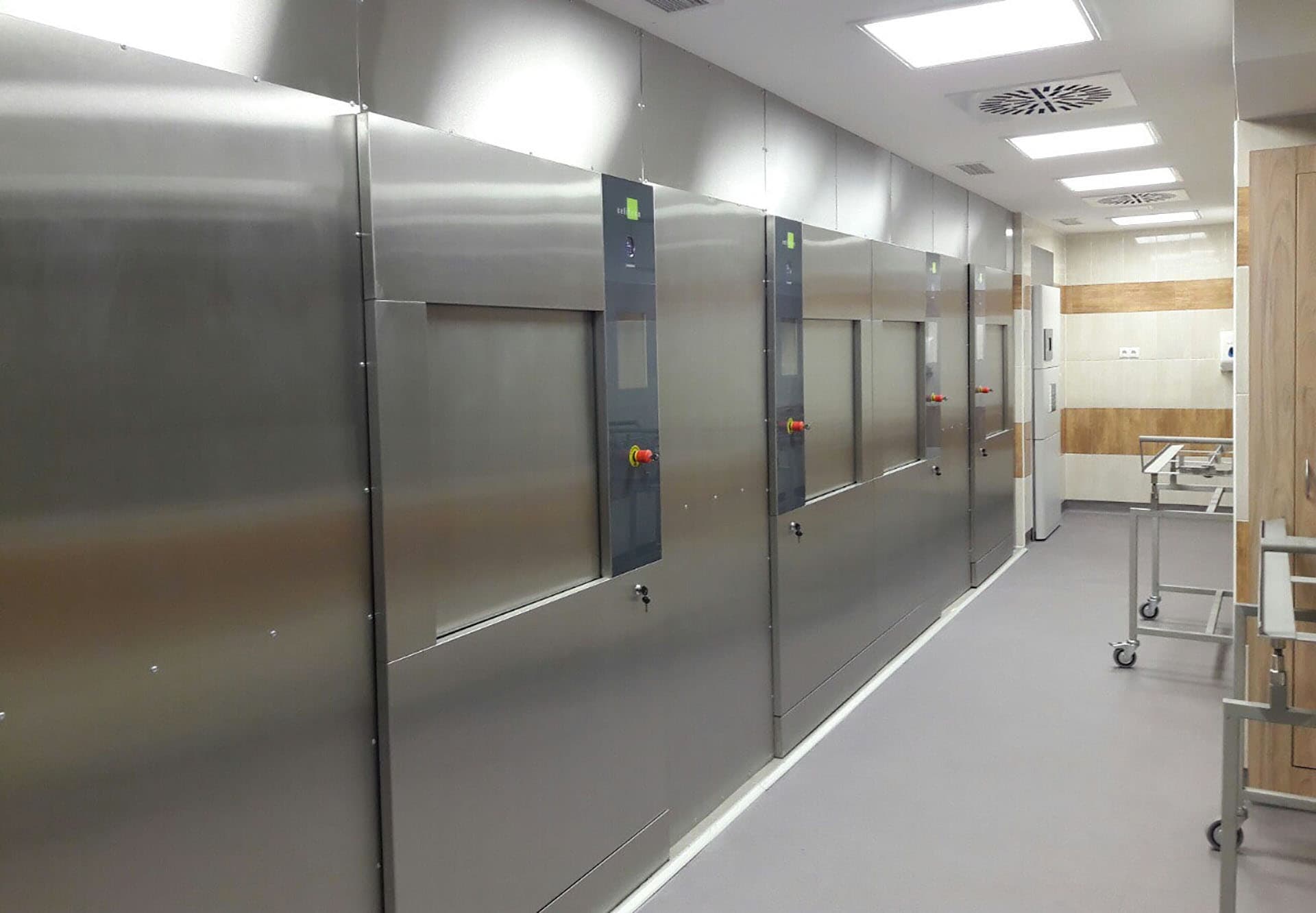 Clean room installation of multiple industrial steam sterilizers within a hospital medical facility.