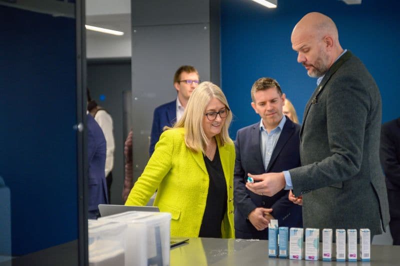 Professionals examining medical products in a laboratory or clinical setting, demonstrating product handling.
