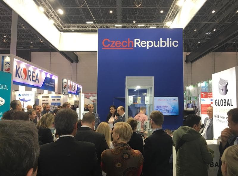 Crowded trade show floor at the Medica exhibition, featuring various company booths and attendees.