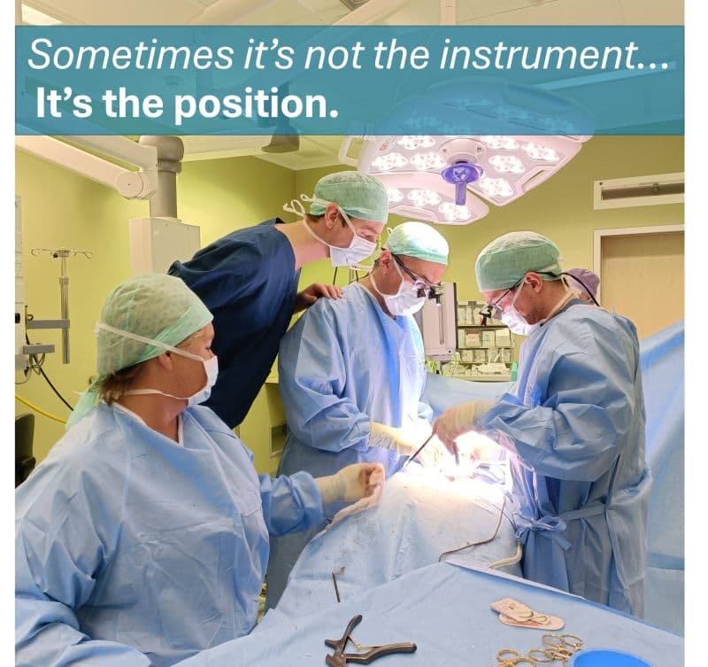 Surgical team performing a procedure in an operating room, demonstrating ergonomic positioning and patient care.