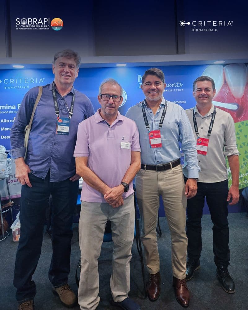 Group portrait of company team members at an industry conference or trade show event.